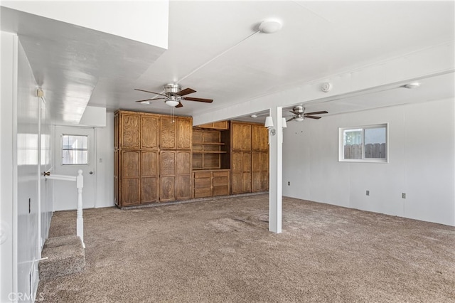 unfurnished living room with a healthy amount of sunlight, ceiling fan, and carpet flooring
