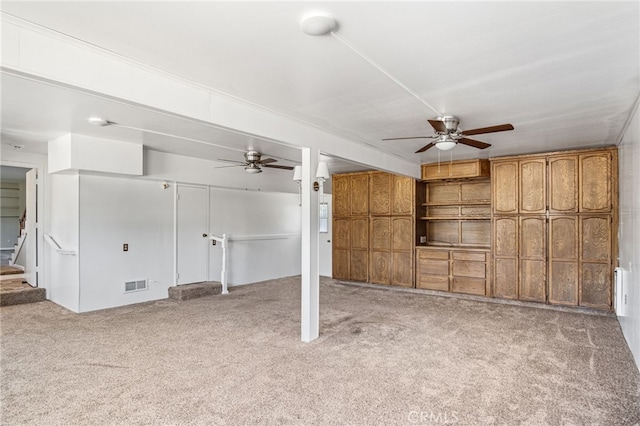 interior space featuring visible vents, carpet flooring, stairs, and ceiling fan