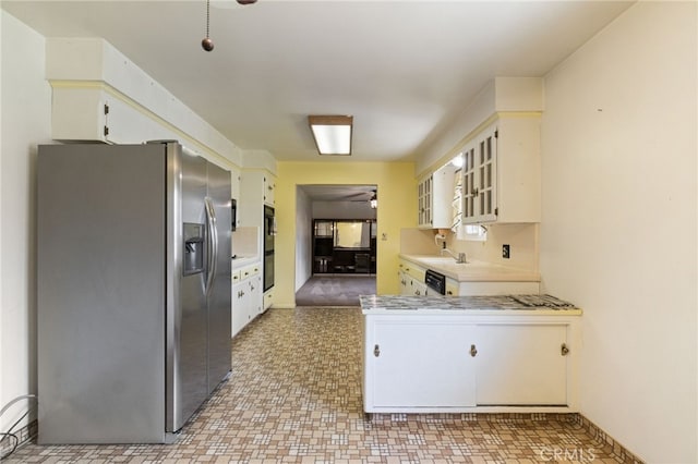 117 Spring Way, Madera, CA 93637 - kitchen with glass insert cabinets, dobule oven black, a ceiling fan, light countertops, and stainless steel fridge