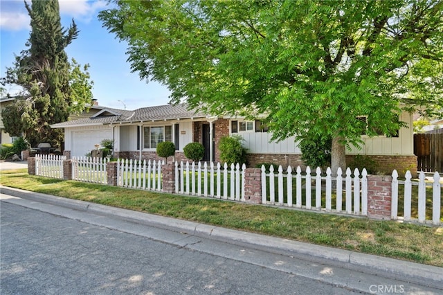 117 Spring Way, Madera, CA 93637 - ranch-style house featuring board and batten siding, a fenced front yard, a garage, brick siding, and concrete driveway