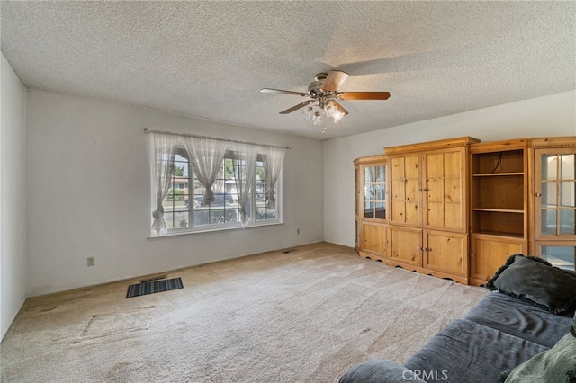 117 Spring Way, Madera, CA 93637 - carpeted living area with a ceiling fan, a textured ceiling, and visible vents