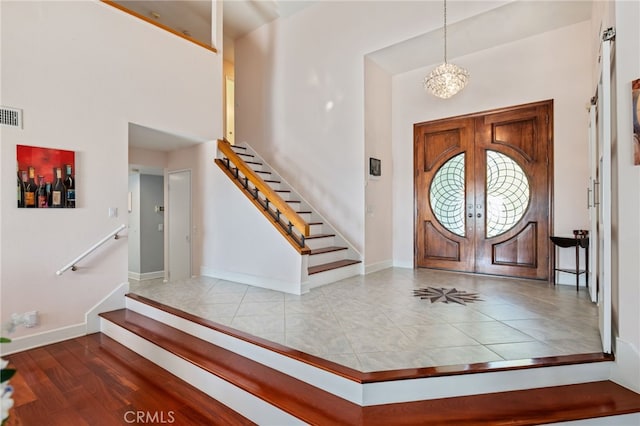 12320 Louise Ave, Granada Hills, CA 91344 - foyer entrance featuring stairs, french doors, baseboards, a chandelier, and a towering ceiling