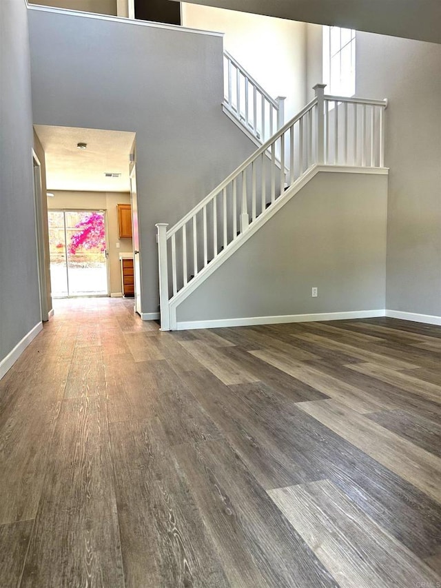 4729 Lagunita Way, Oceanside, CA 92057 - unfurnished living room featuring wood finished floors, stairway, and baseboards