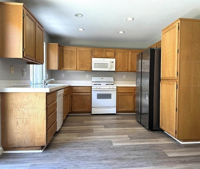 4729 Lagunita Way, Oceanside, CA 92057 - kitchen with white appliances, recessed lighting, wood finished floors, brown cabinets, and a sink