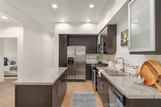 12920 W Runway Rd Unit 121, Playa Vista, CA 90094 - kitchen with a sink, a center island, stainless steel appliances, and dark brown cabinets