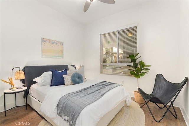 bedroom with baseboards, a ceiling fan, and wood finished floors
