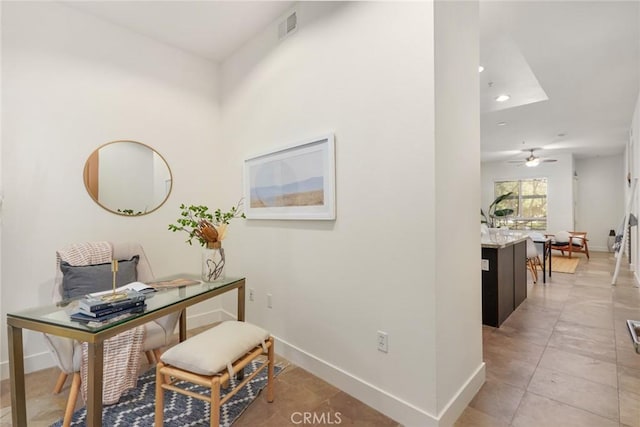 interior space with baseboards, a ceiling fan, and recessed lighting