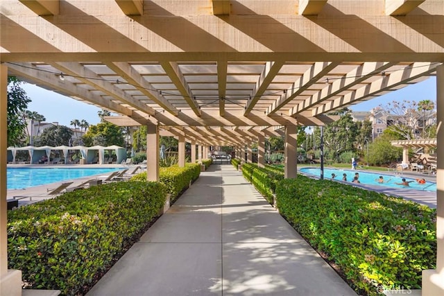 view of property's community with a pergola and a pool