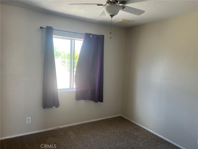 empty room featuring baseboards, a ceiling fan, carpet flooring, and visible vents