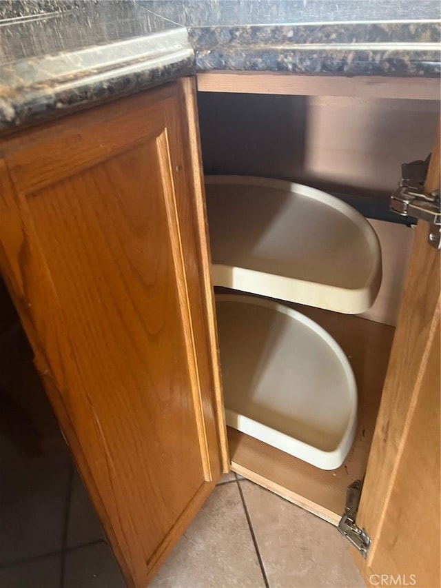 room details featuring dark countertops and brown cabinetry