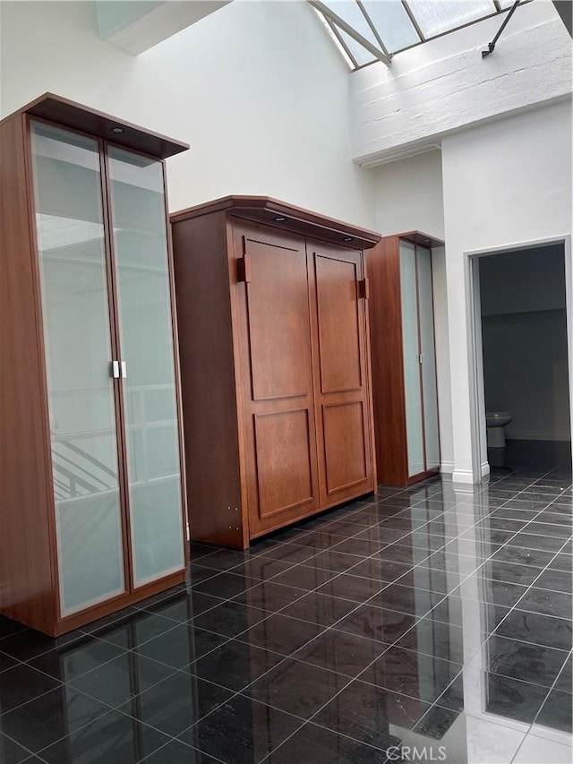 420 S San Pedro St Unit 102, Los Angeles, CA 90013 - bathroom with a towering ceiling, a skylight, and toilet