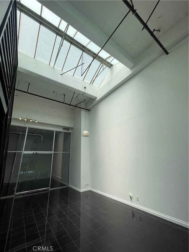 420 S San Pedro St Unit 102, Los Angeles, CA 90013 - spare room with a skylight, tile patterned floors, and baseboards