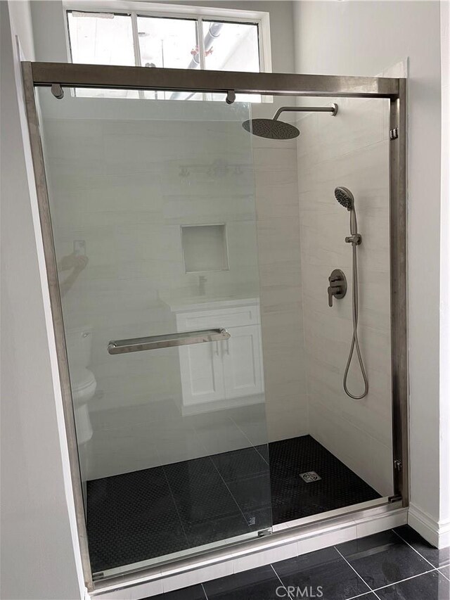 420 S San Pedro St Unit 102, Los Angeles, CA 90013 - bathroom with a shower stall, tile patterned floors, and toilet