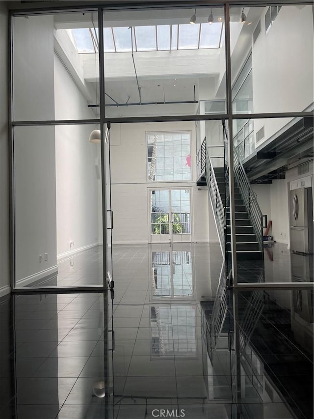 420 S San Pedro St Unit 102, Los Angeles, CA 90013 - stairway with baseboards, a skylight, and washer / clothes dryer