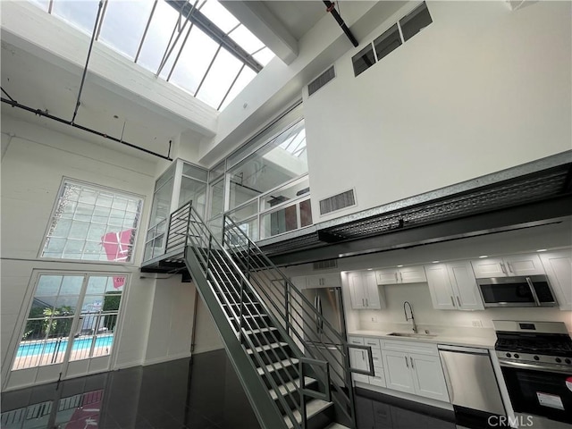 420 S San Pedro St Unit 102, Los Angeles, CA 90013 - stairs featuring a high ceiling and french doors