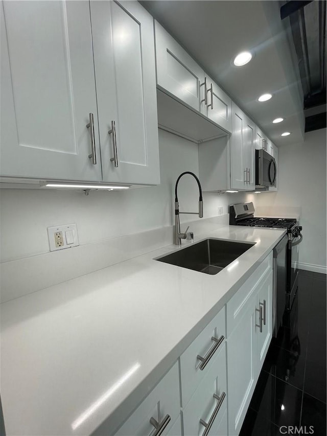 420 S San Pedro St Unit 102, Los Angeles, CA 90013 - kitchen featuring stainless steel gas range, a sink, black microwave, recessed lighting, and light countertops