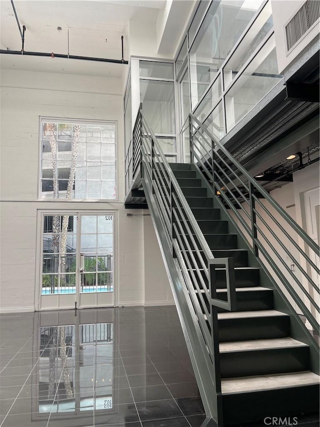 420 S San Pedro St Unit 102, Los Angeles, CA 90013 - stairway featuring tile patterned floors and baseboards