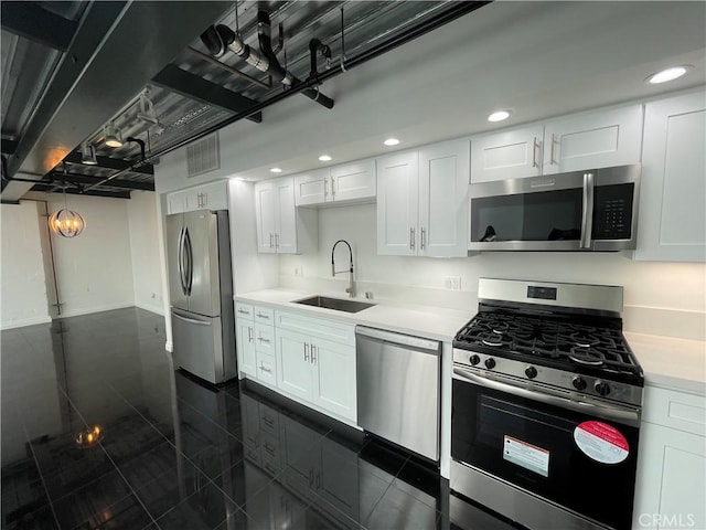 420 S San Pedro St Unit 102, Los Angeles, CA 90013 - kitchen featuring stainless steel appliances, a sink, light countertops, white cabinetry, and recessed lighting
