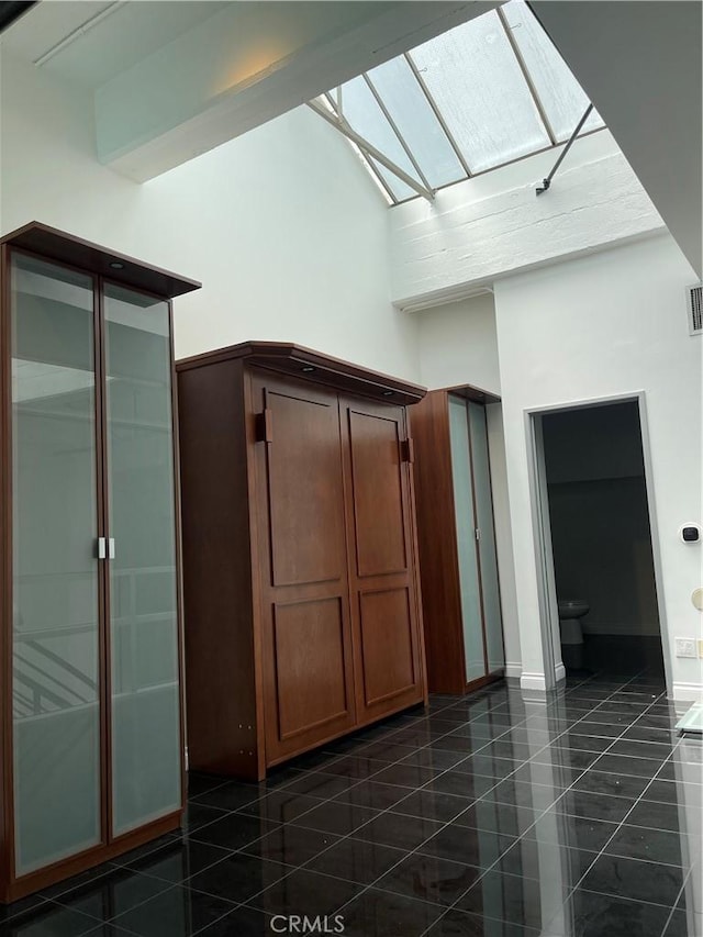 420 S San Pedro St Unit 102, Los Angeles, CA 90013 - additional living space with a skylight, a high ceiling, and baseboards