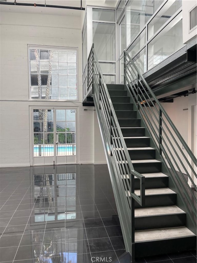 420 S San Pedro St Unit 102, Los Angeles, CA 90013 - staircase featuring tile patterned flooring and baseboards