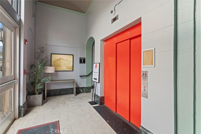 420 S San Pedro St Unit 102, Los Angeles, CA 90013 - foyer featuring ornamental molding, arched walkways, a high ceiling, and elevator