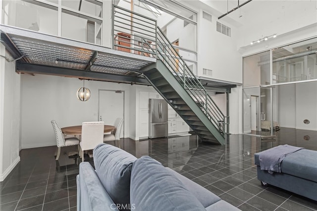 420 S San Pedro St Unit 102, Los Angeles, CA 90013 - living room with stairs, tile patterned flooring, and a high ceiling