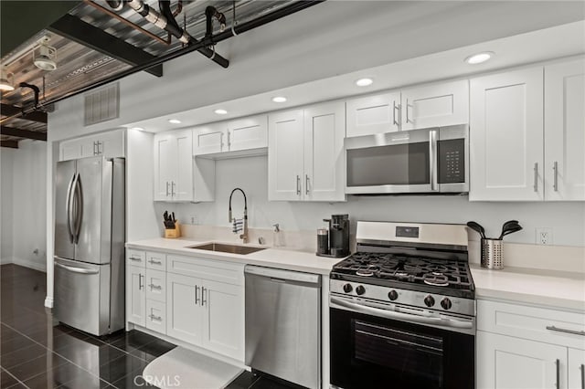420 S San Pedro St Unit 102, Los Angeles, CA 90013 - kitchen featuring appliances with stainless steel finishes, recessed lighting, light countertops, white cabinetry, and granite tiled floors
