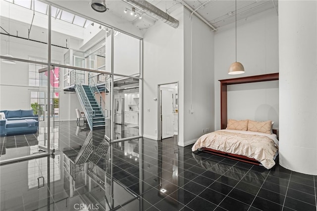 420 S San Pedro St Unit 102, Los Angeles, CA 90013 - bedroom with a towering ceiling, access to exterior, stainless steel refrigerator, and tile patterned floors