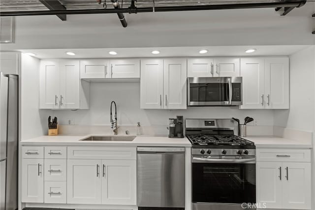 420 S San Pedro St Unit 102, Los Angeles, CA 90013 - kitchen featuring appliances with stainless steel finishes, white cabinets, light countertops, and recessed lighting