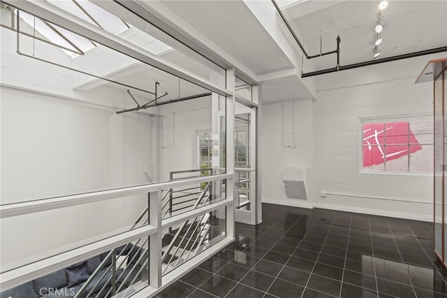 420 S San Pedro St Unit 102, Los Angeles, CA 90013 - walk in closet featuring tile patterned floors and a skylight