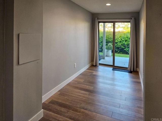 interior space featuring baseboards, recessed lighting, and hardwood / wood-style floors