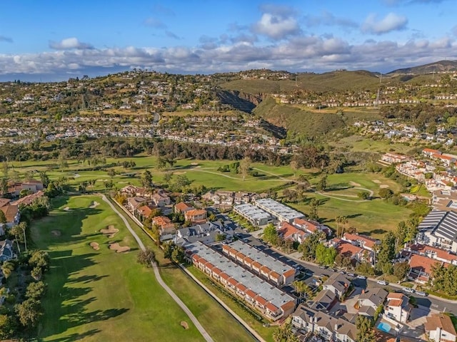 bird's eye view with view of golf course, a mountain view, and a residential view