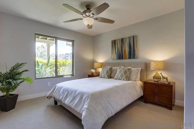 bedroom featuring baseboards, light carpet, and a ceiling fan
