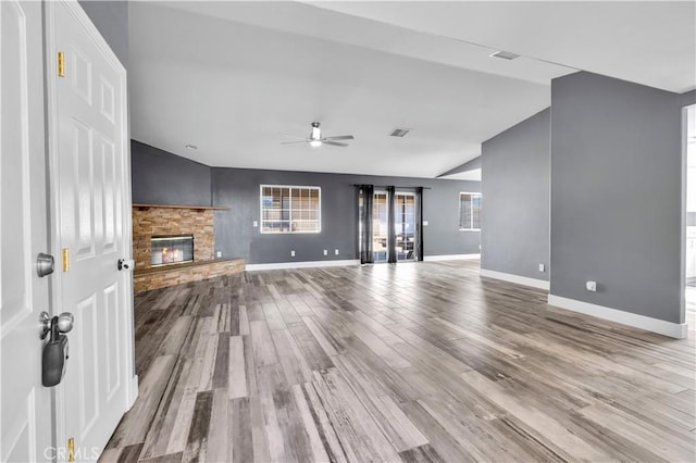 58957 Pueblo Trl, Yucca Valley, CA 92284 - unfurnished living room with ceiling fan, a fireplace, wood finished floors, baseboards, and lofted ceiling
