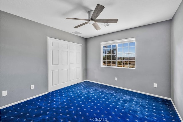 58957 Pueblo Trl, Yucca Valley, CA 92284 - unfurnished bedroom with carpet floors, baseboards, a closet, and ceiling fan