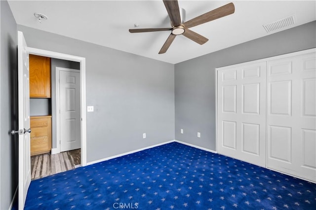 58957 Pueblo Trl, Yucca Valley, CA 92284 - unfurnished bedroom with a ceiling fan, visible vents, baseboards, a closet, and carpet flooring