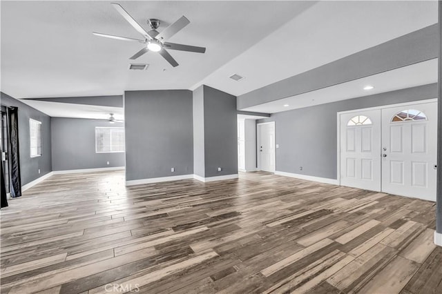 58957 Pueblo Trl, Yucca Valley, CA 92284 - unfurnished living room featuring ceiling fan, baseboards, wood finished floors, lofted ceiling, and visible vents