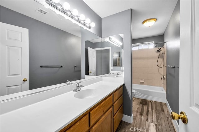 58957 Pueblo Trl, Yucca Valley, CA 92284 - full bath with visible vents, vanity, shower / bathtub combination, wood finished floors, and toilet
