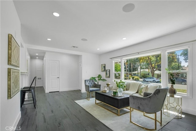 living area with baseboards, recessed lighting, wood finished floors, and visible vents