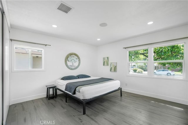 bedroom with visible vents, recessed lighting, baseboards, and wood finished floors