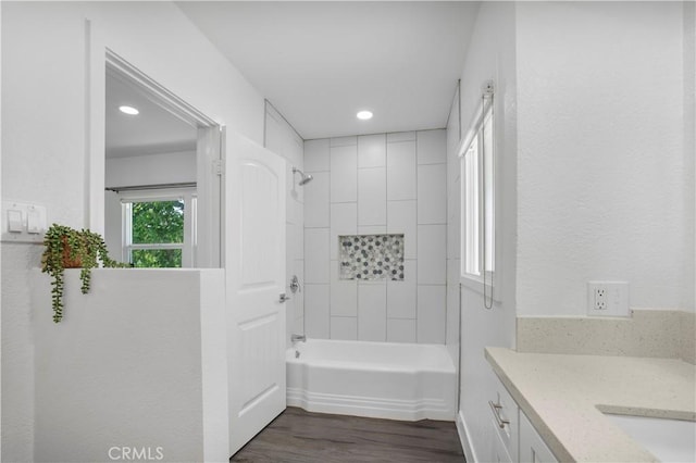 full bathroom with tub / shower combination, recessed lighting, wood finished floors, and vanity