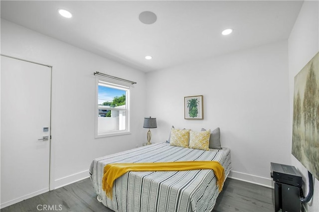 bedroom with baseboards, recessed lighting, and wood finished floors