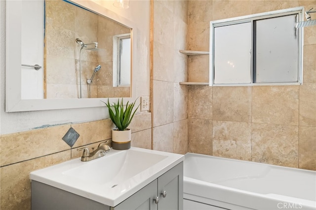 full bathroom with tile walls and vanity