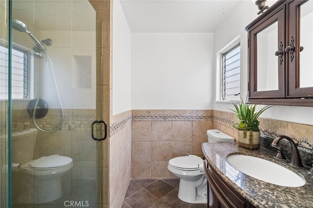 full bathroom with vanity, a stall shower, a wealth of natural light, and toilet