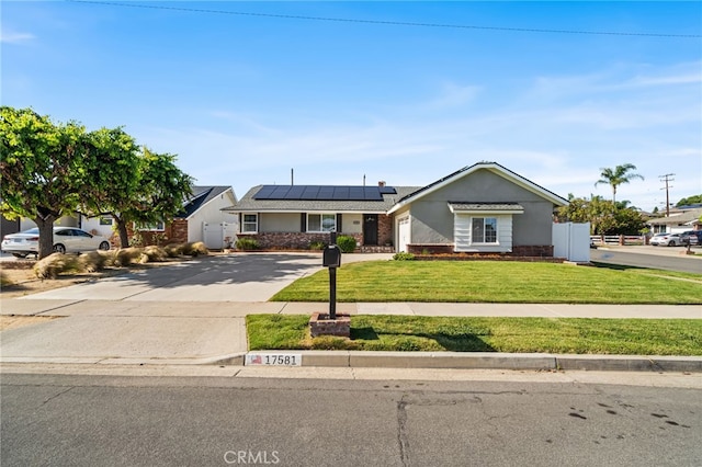 view of front of house featuring a garage, a front lawn, stucco siding, concrete driveway, and solar panels