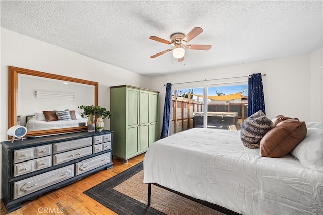 bedroom with a closet, light wood finished floors, and a textured ceiling