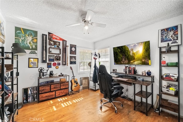 office space with a ceiling fan, a textured ceiling, and wood finished floors