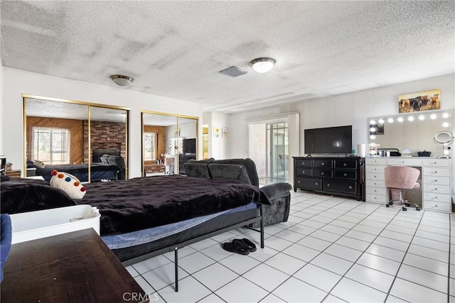9684 Hemlock St, Rancho Cucamonga, CA 91730 - bedroom featuring two closets, multiple windows, light tile patterned floors, and a textured ceiling