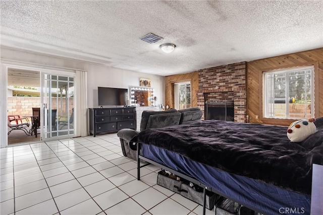 9684 Hemlock St, Rancho Cucamonga, CA 91730 - bedroom featuring access to exterior, multiple windows, wood walls, light tile patterned flooring, and a fireplace