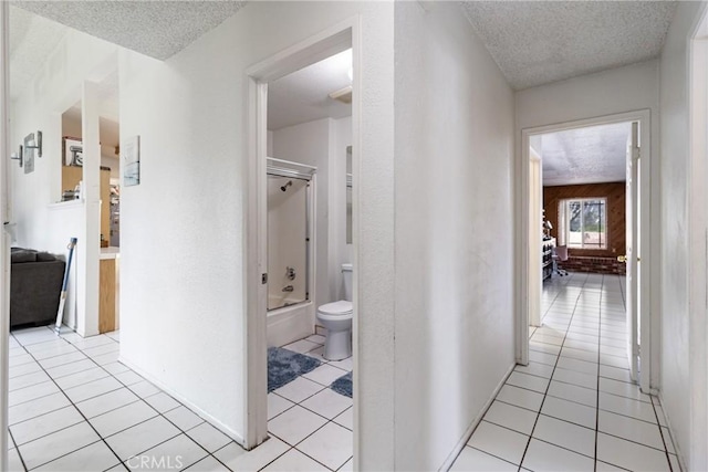 9684 Hemlock St, Rancho Cucamonga, CA 91730 - corridor featuring a textured ceiling and light tile patterned flooring